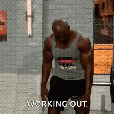 Man Lifting Barbell In Gym With Tank Top And Shorts GIF