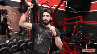 Man Lifting Dumbbell In Black Apocalypse Shirt GIF
