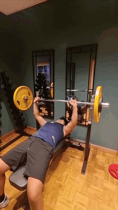 Man Lifting Yellow Barbell On Bench GIF