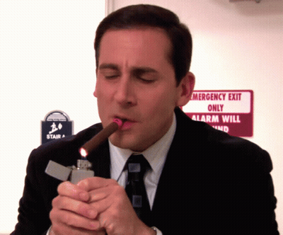 Man Lighting Cigar Near Emergency Exit GIF