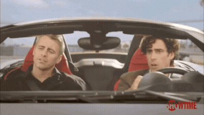 Man Looking At Camera In Crowd GIF