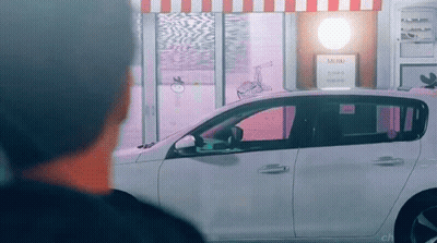 Man Looking At Car Parked By Store With Mini Sign GIF
