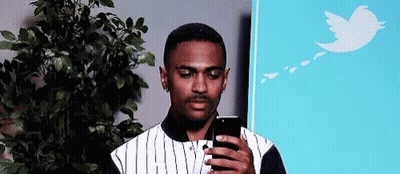 Man Looking At Cell Phone In Front Of Tree GIF
