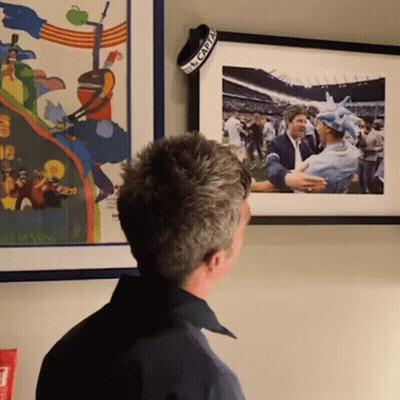 Man Looking At Framed Picture With El Capitan Band GIF