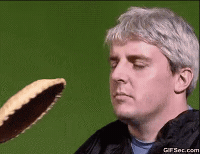 Man Looking At Pancake Thrown At Him GIF
