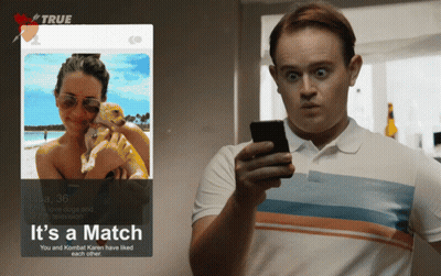 Man Looking At Phone Next To Tinder Profile GIF