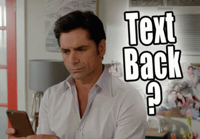 Man Looking At Phone Saying Text Back GIF