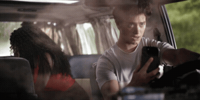 Man Looking At Phone While Driving GIF