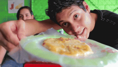 Man Looking At Plate Of Food While Woman Looks On GIF