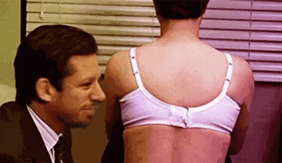 Man Looking At Woman's Back In Bra GIF