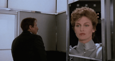 Man Looking At Woman's Reflection GIF