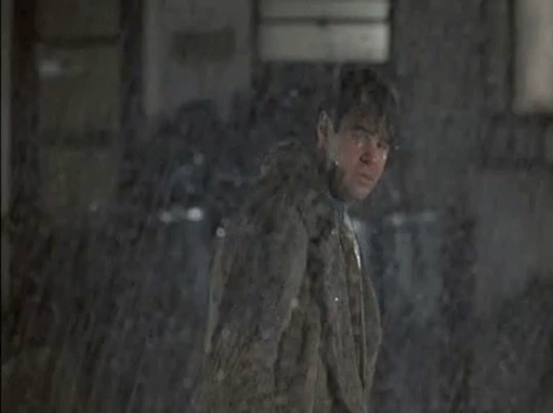 Man Looking Out Window At People Sitting At Tables In Rain GIF