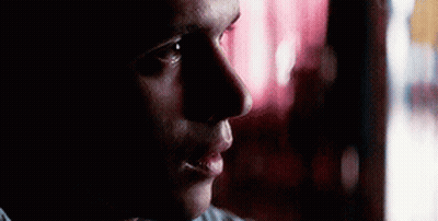 Man Looking Out Window In Dark Room GIF