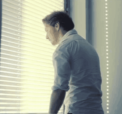 Man Looking Out Window With Blinds GIF