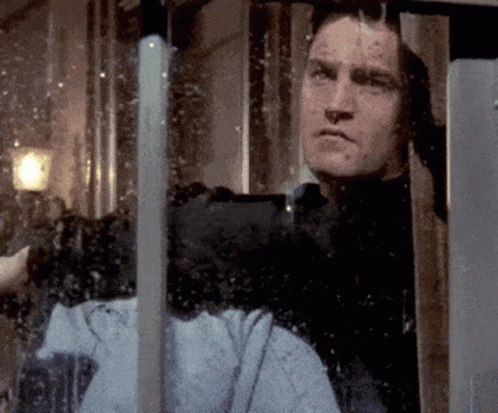 Man Looking Out Window With Reflection Of Person GIF