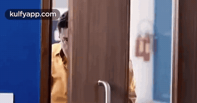 Man Looking Out Wooden Door GIF