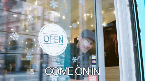 Man Looking Through Glass Door With Open Sign GIF