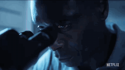 Man Looking Through Microscope In Dark Room GIF