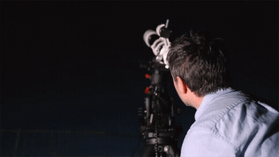 Man Looking Through Telescope At Night Sky GIF