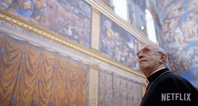 Man Looking Up At Painting With Netflix Logo GIF