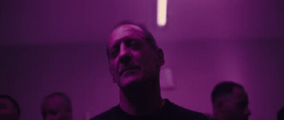 Man Looking Up In Dark Room With Purple Lights GIF