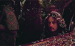 Man Lying In Confetti With Head Covered GIF