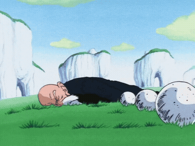 Man Lying In Grass Among Balls And Mountains GIF