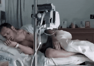 Man Lying In Hospital Bed With IV GIF