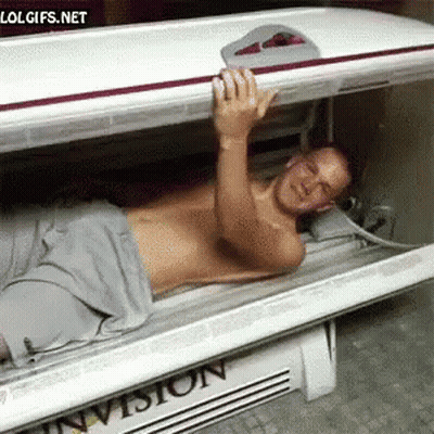 Man Lying In Invision Tanning Bed GIF