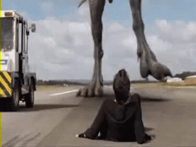 Man Lying Next To Large Dinosaur GIF
