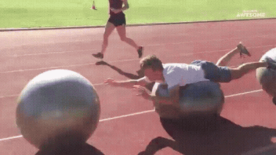 Man Lying On Ball On Track GIF
