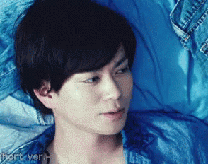 Man Lying On Bed In Blue Shirt GIF