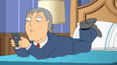 Man Lying On Bed Looking At Cell Phone GIF