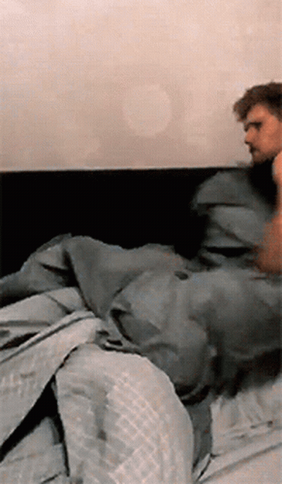 Man Lying On Bed With Gray Blanket GIF
