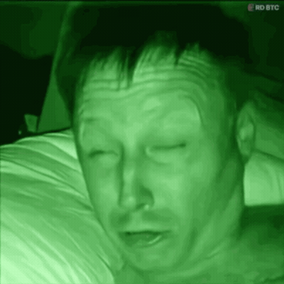 Man Lying On Bed With RDBTC Screen GIF