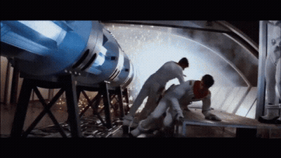 Man Lying On Ground By Large Machine GIF