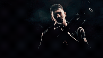 Man Lying On Ground With Machine Gun GIF