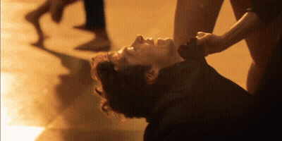 Man Lying On Ground With Woman Holding Neck GIF