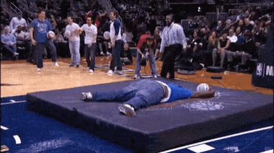 Man Lying On Mat In Front Of NBA Sign GIF
