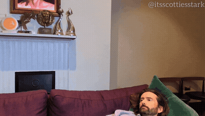 Man Lying On Purple Couch GIF