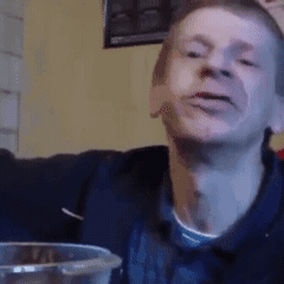 Man Making Funny Face At Table With Glass Of Water GIF