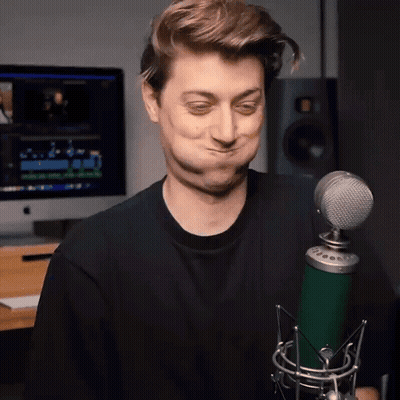 Man Making Funny Face Holding Green Microphone GIF