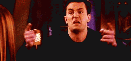 Man Making Funny Face Holding Pink Socks GIF