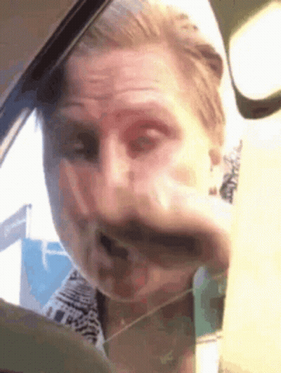 Man Making Funny Face In Car GIF