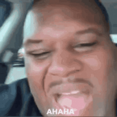 Man Making Funny Face In Car With Eyes Closed GIF