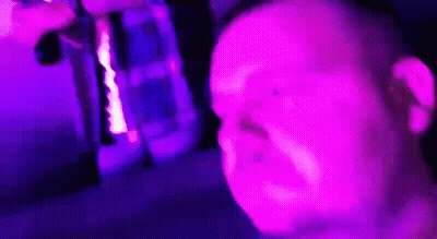 Man Making Funny Face In Front Of Purple Light GIF