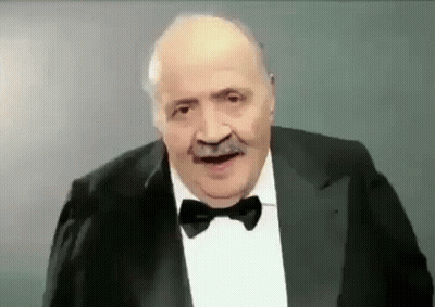 Man Making Funny Face In Suit Bow Tie GIF