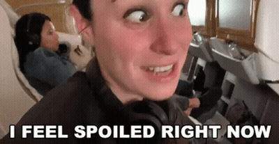 Man Making Funny Face On Plane With Woman GIF