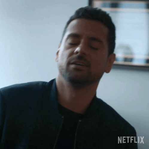 Man Making Funny Face With Eyes Closed In Mirror GIF