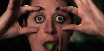 Man Making Funny Face With Grape In Mouth GIF